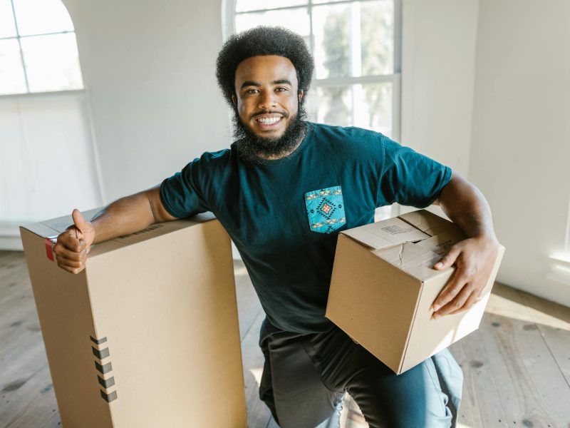 a bearded man holding a box